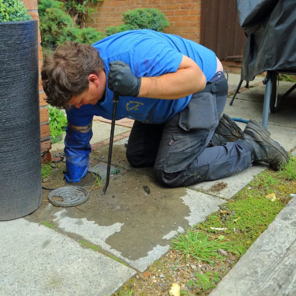 Warrington Drainage Solutions employee clearing a blocked drain